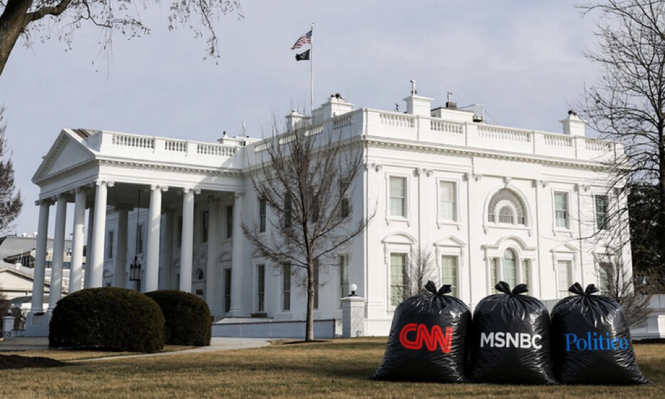 The image depicts the White House with three large black garbage bags placed on the lawn in the foreground. The bags are labeled with the logos "CNN," "MSNBC," and "Politico." The American flag and another flag are visible on the White House roof. There are bare trees and well-trimmed hedges surrounding the area.
