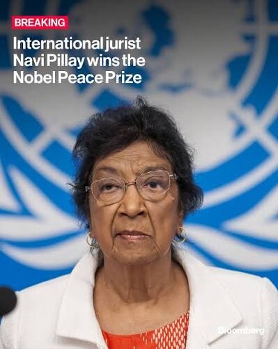 Photograph of a woman standing in front of a backdrop with a blue and white logo. Text on the image reads: "BREAKING International jurist Navi Pillay wins the Nobel Peace Prize." The logo appears to be linked to an international organization. The source of this text is "Bloomberg" located at the bottom right corner.